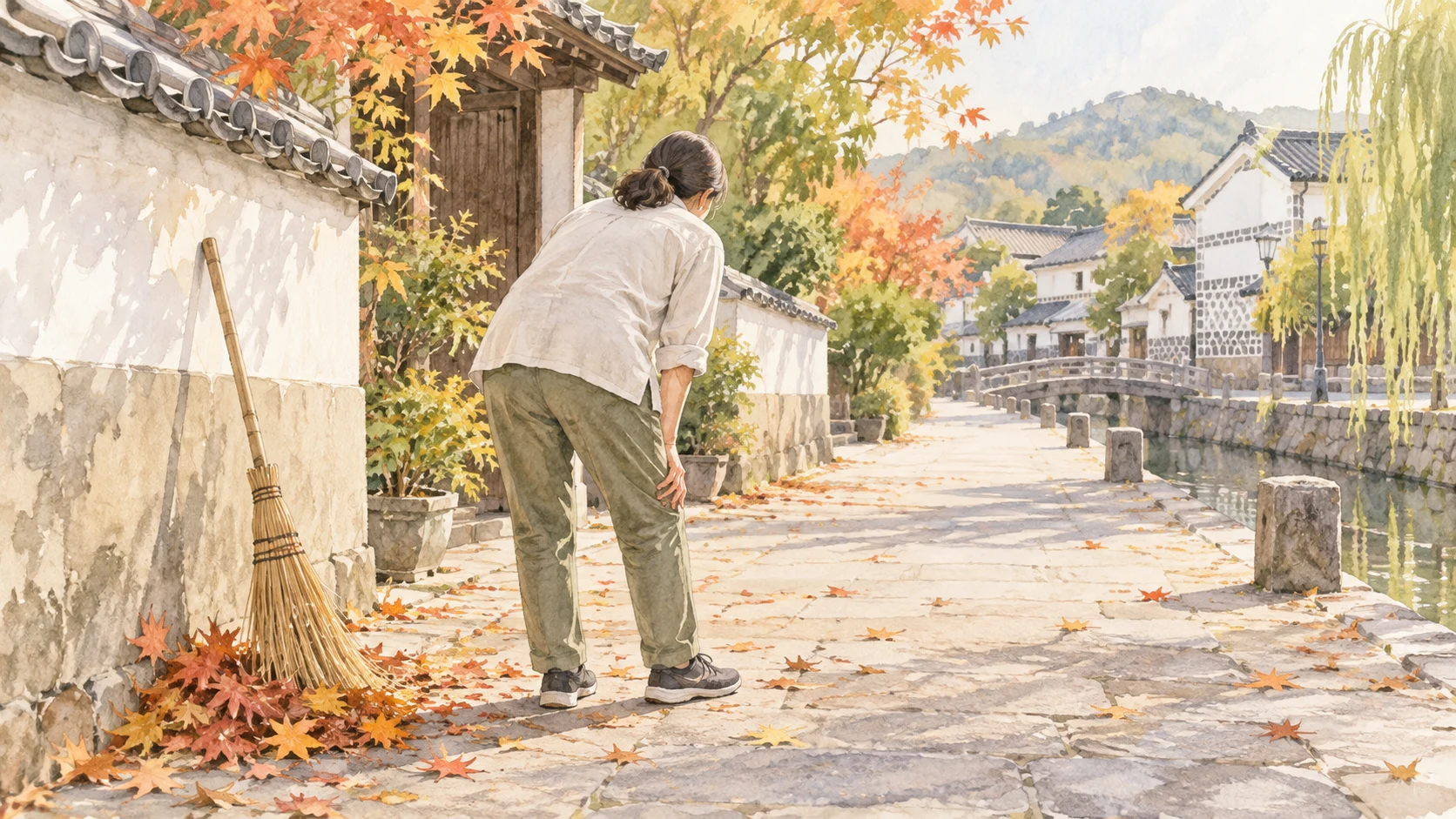 秋の倉敷の町並みで落ち葉掃きの手を止め、膝に手を添える方の後ろ姿の淡い水彩イラスト